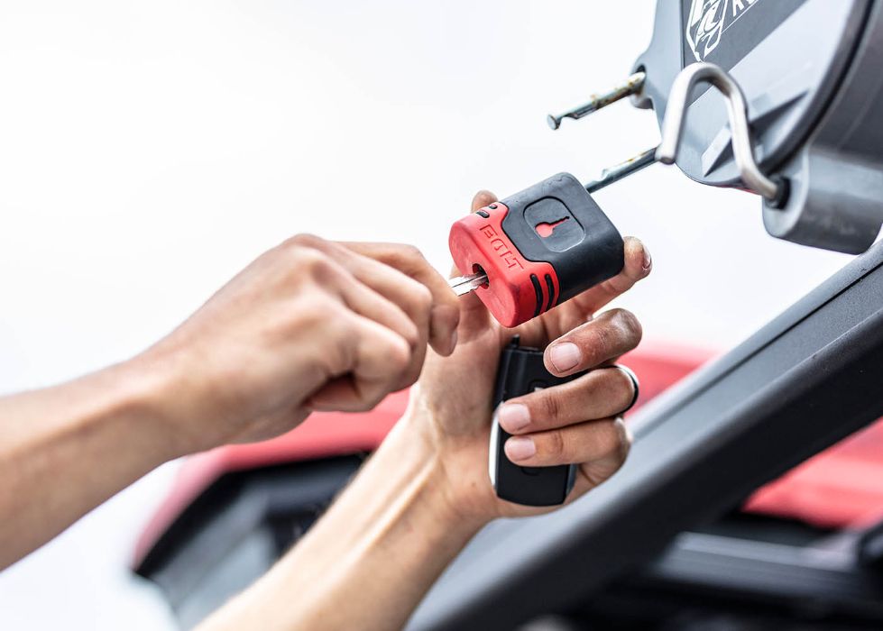Hand unlocking a BOLT Lock with a car key